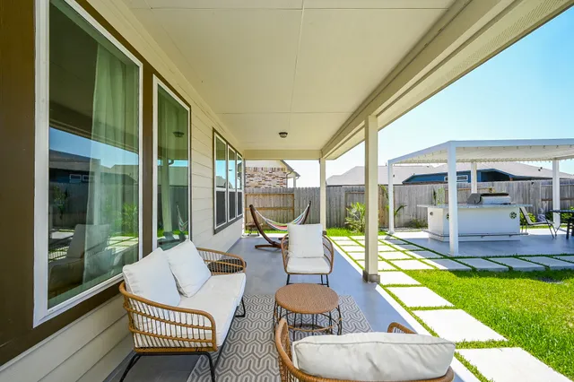 a balcony with chairs and a table