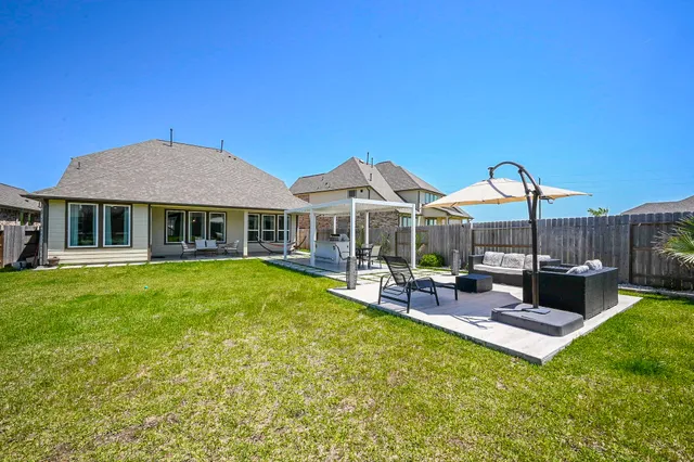 a view of a house with pool and chairs