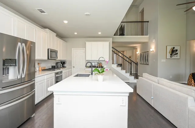 a kitchen that has a sink and a refrigerator