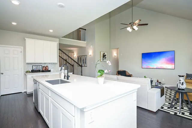 a kitchen with a stove a sink a dining table and chairs