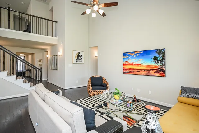 a living room with furniture and a chandelier