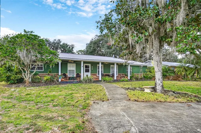 a view of a house with backyard porch and garden