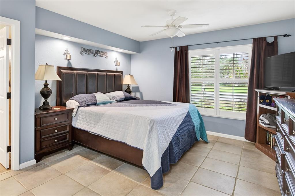 2218 River Ridge Road DeLand, FL 32720 - Photo 16 of 52 a bedroom with a bed and a flat tv screen on dresser