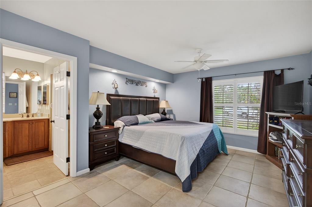 2218 River Ridge Road DeLand, FL 32720 - Photo 17 of 52 a bedroom with a bed and a flat screen tv