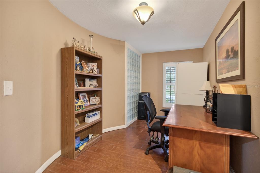 2218 River Ridge Road DeLand, FL 32720 - Photo 22 of 52 a view of a workspace with furniture and a window
