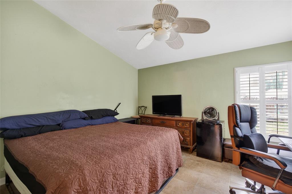 2218 River Ridge Road DeLand, FL 32720 - Photo 30 of 52 a bedroom with a bed and a flat screen tv