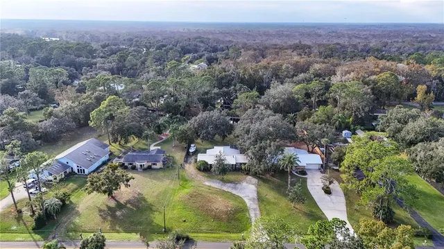 an aerial view of residential house with outdoor space and swimming pool