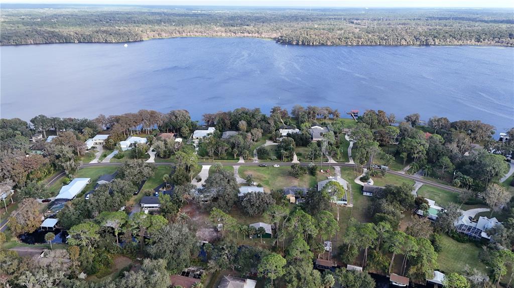 2218 River Ridge Road DeLand, FL 32720 - Photo 40 of 52 an aerial view of a house with a yard and lake view