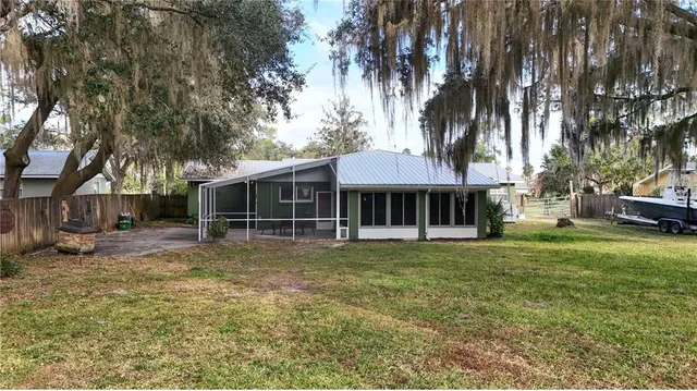 a view of a patio with lawn chairs under an umbrella