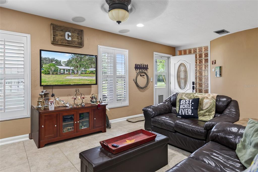 2218 River Ridge Road DeLand, FL 32720 - Photo 6 of 52 a living room with furniture and a large window