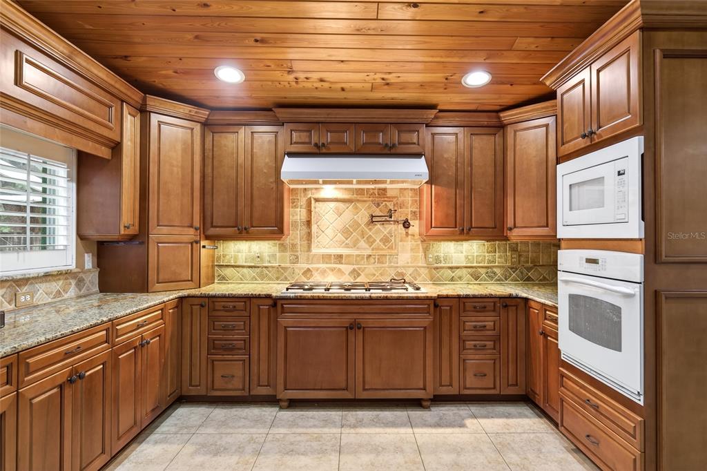 2218 River Ridge Road DeLand, FL 32720 - Photo 9 of 52 a kitchen with a sink stove and cabinets