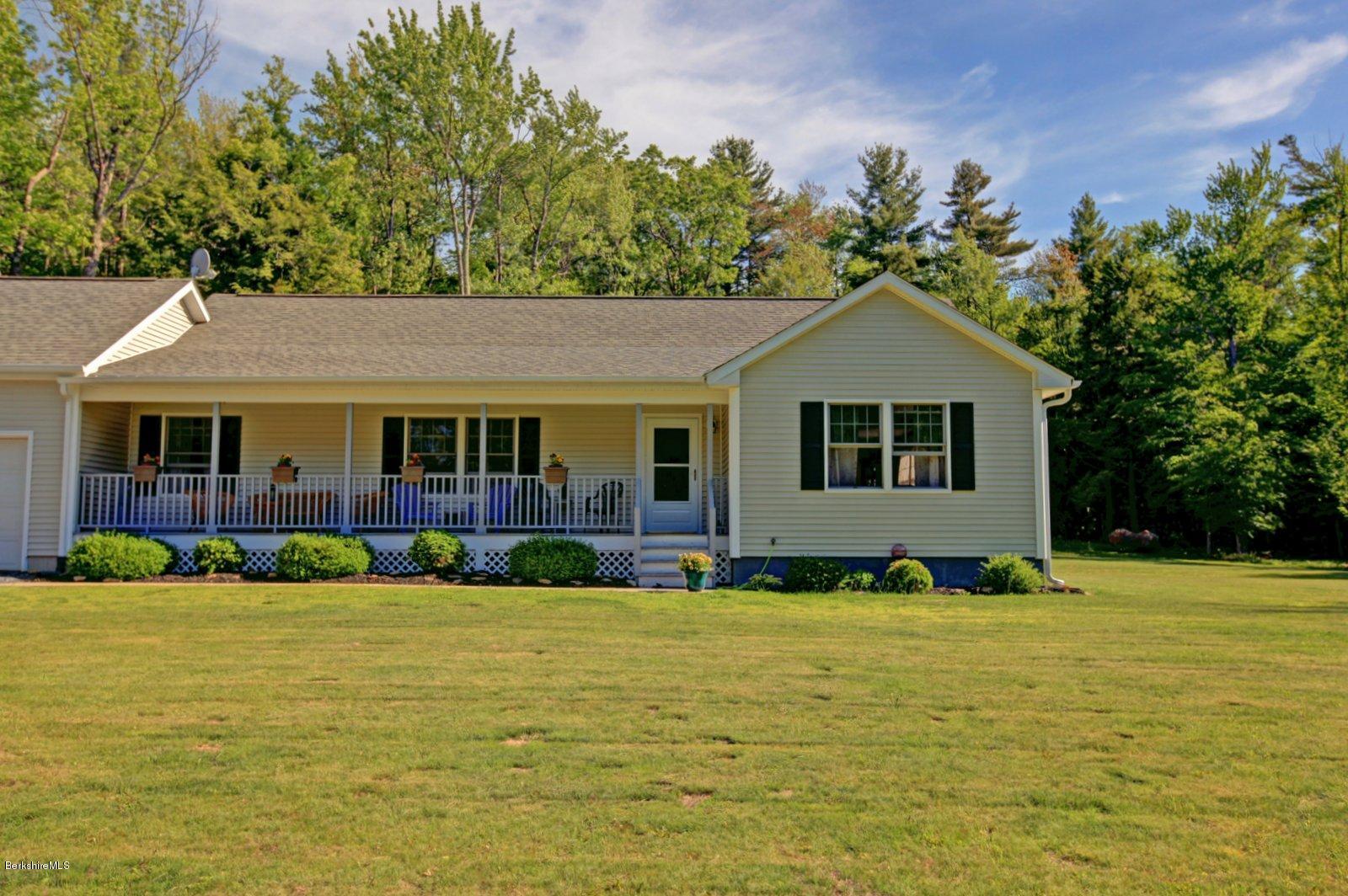 32 West Hubbard Road Sandisfield, MA 01255 - Photo 22 of 29 a front view of a house with swimming pool and green space