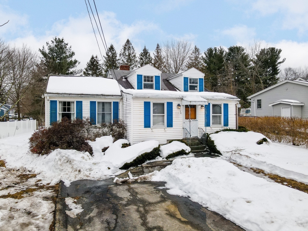 126 Groton Road Chelmsford, MA 01863 - Photo 33 of 38 a front view of a house with a yard covered in snow