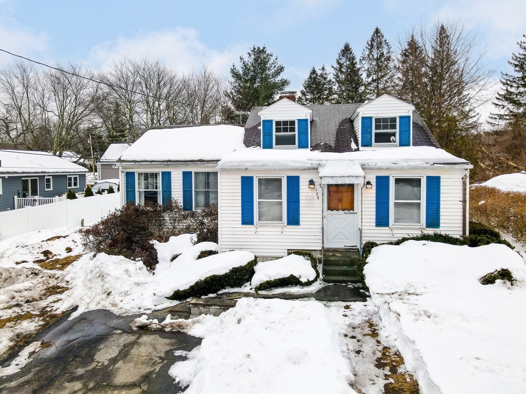 126 Groton Road Chelmsford, MA 01863 - Photo 34 of 38 a front view of a house with a yard covered in snow