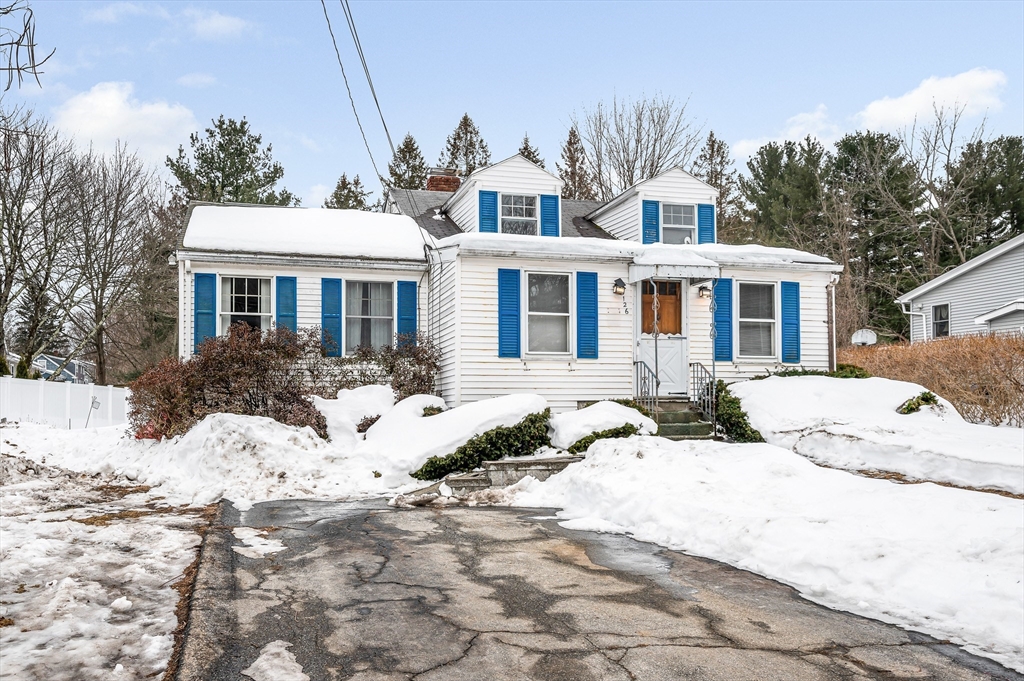 126 Groton Road Chelmsford, MA 01863 - Photo 37 of 38 a view of a white house with a yard covered in snow