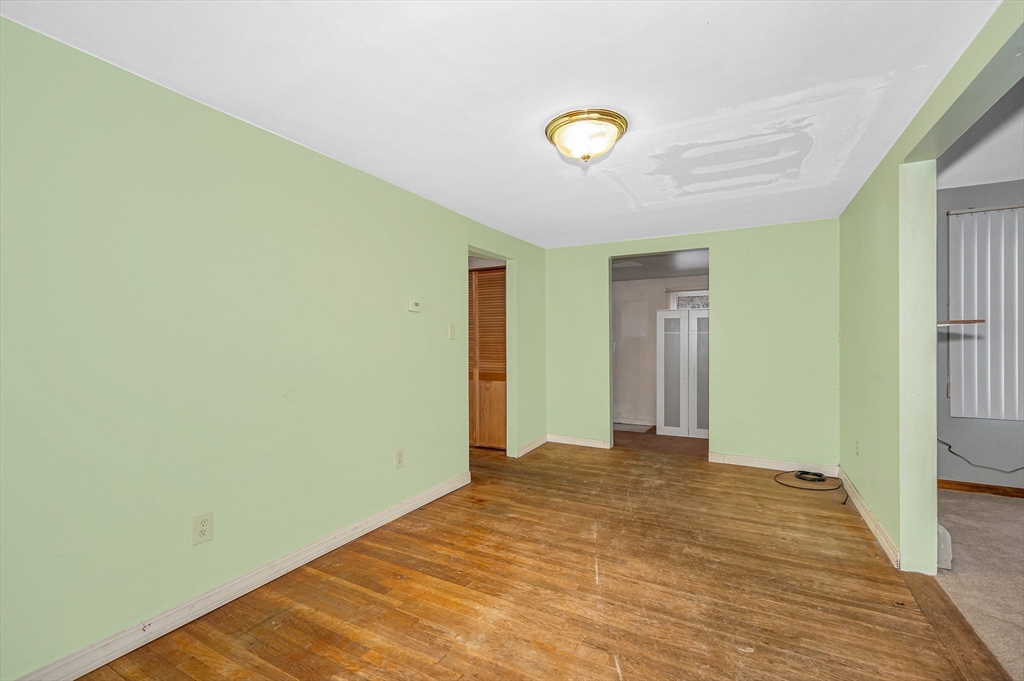 126 Groton Road Chelmsford, MA 01863 - Photo 7 of 38 a view of a livingroom with wooden floor and a bathroom