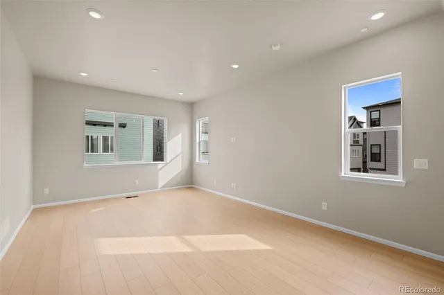 a view of kitchen with kitchen island a refrigerator a sink dishwasher with wooden floor and dining table chair