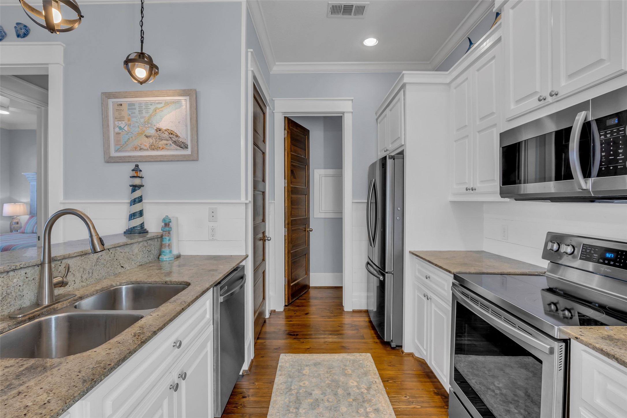 911 Tidelands Crystal Beach, TX 77650 - Photo 15 of 25 a kitchen with stainless steel appliances granite countertop a sink stove and refrigerator