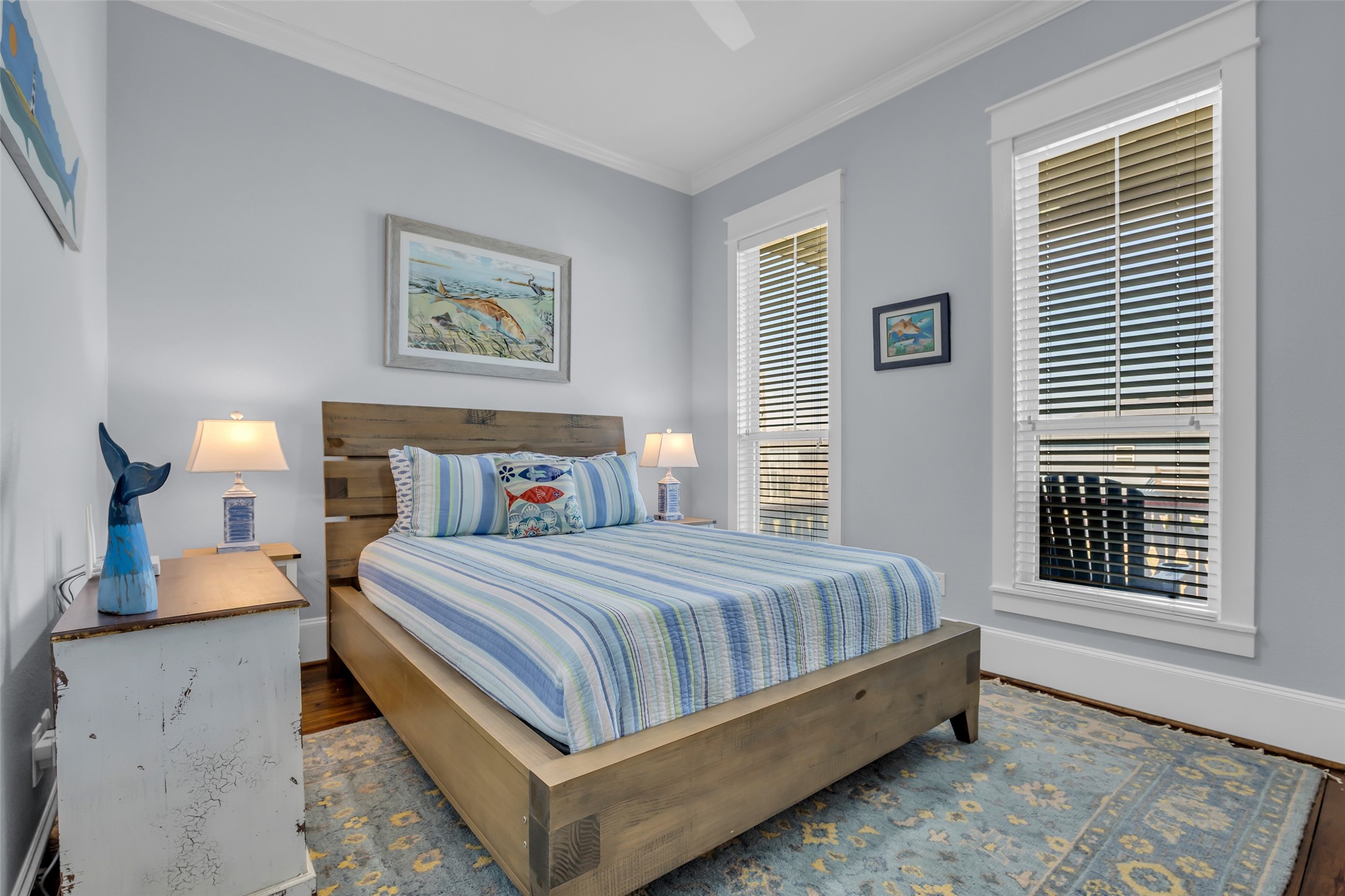 911 Tidelands Crystal Beach, TX 77650 - Photo 18 of 25 a bedroom with a bed and painting on the wall