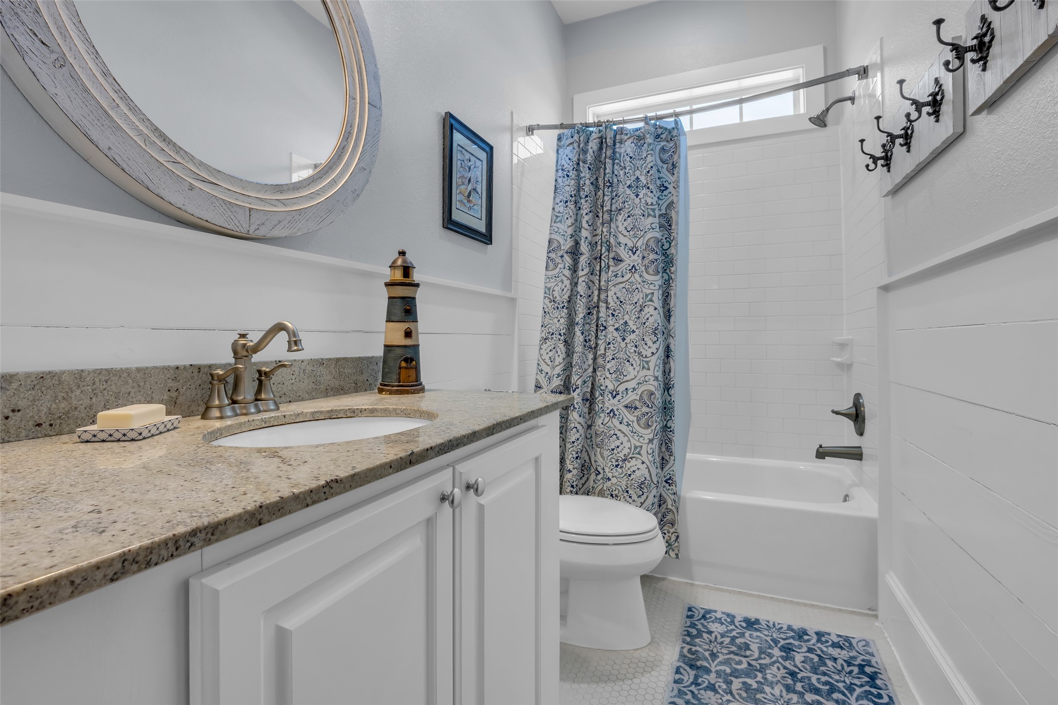 911 Tidelands Crystal Beach, TX 77650 - Photo 19 of 25 a bathroom with a granite countertop sink a toilet and shower
