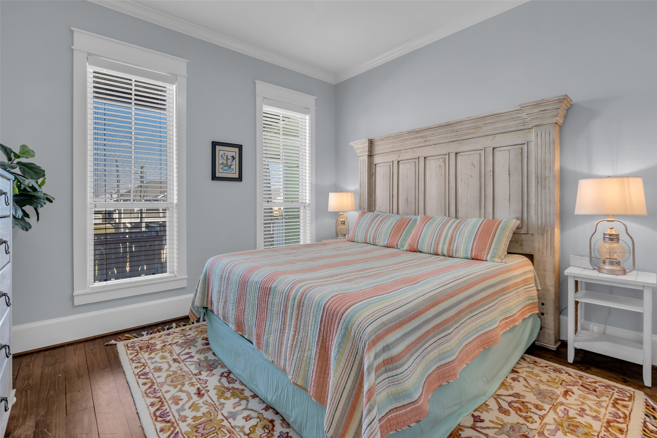 911 Tidelands Crystal Beach, TX 77650 - Photo 21 of 25 a bedroom with a bed and a lamp next to a window