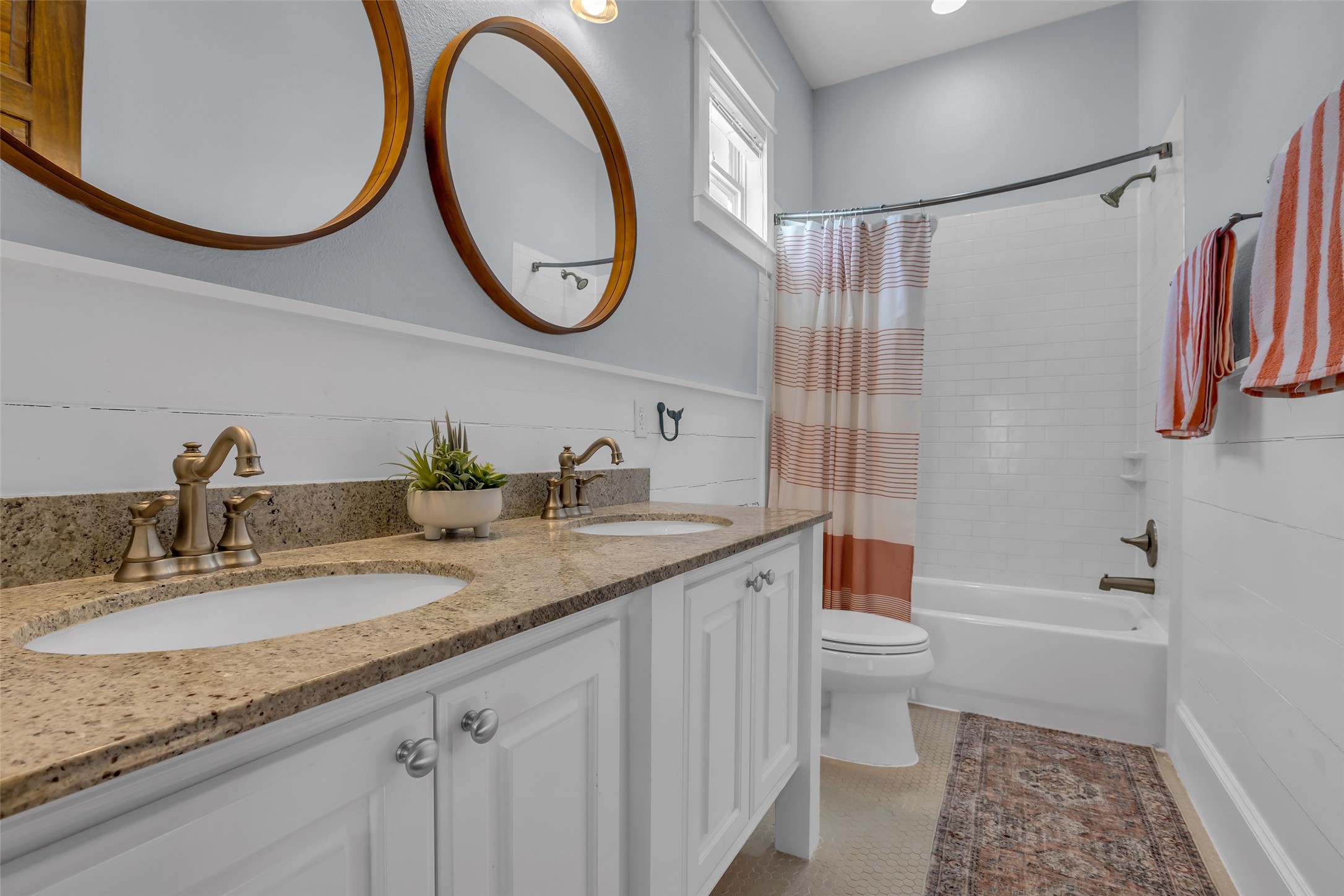 911 Tidelands Crystal Beach, TX 77650 - Photo 22 of 25 a bathroom with a granite countertop toilet sink and a mirror