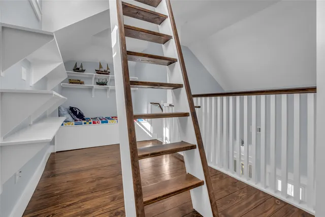 a view of a hallway with wooden floor and entryway