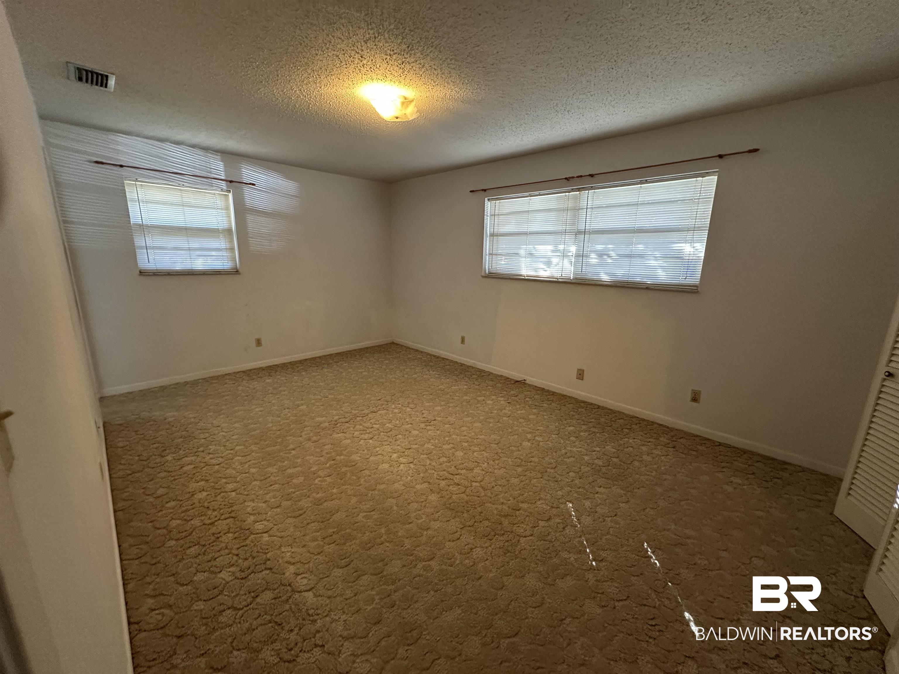 1 Yupon Circle Foley, AL 36535 - Photo 17 of 30 Spare room with a textured ceiling and baseboards