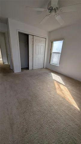a bathroom with a granite countertop sink a toilet and a mirror