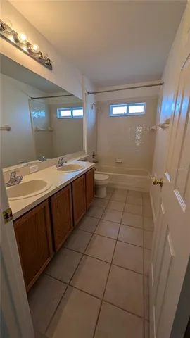 a large bathroom with a sink a vanity and a mirror