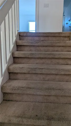 a view of a room with wooden floor and white walls