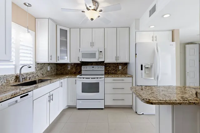 a kitchen with stainless steel appliances a refrigerator and a stove