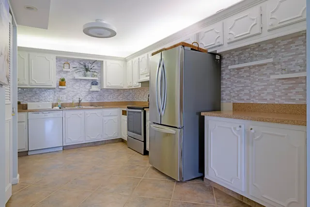 a kitchen with a sink stove and cabinets