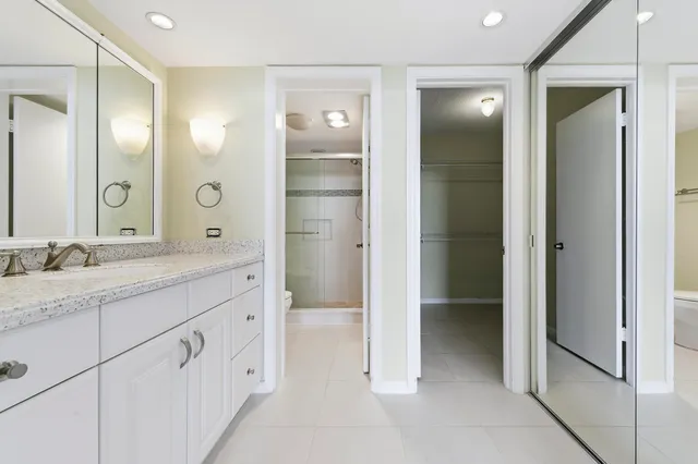 a spacious bathroom with a granite countertop sink mirror and toilet