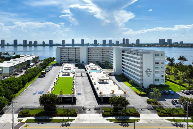 a view of swimming pool with outdoor seating and city view