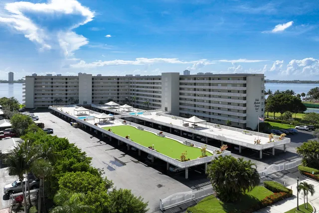 a view of swimming pool outdoor seating and city view