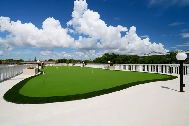 a view of swimming pool with outdoor seating and city view