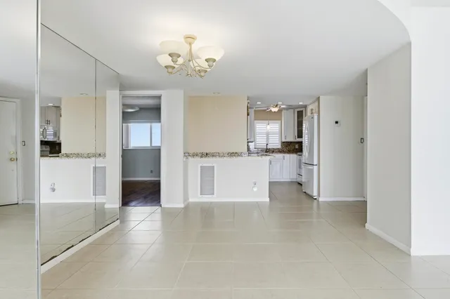 a view of a kitchen with a sink and a refrigerator