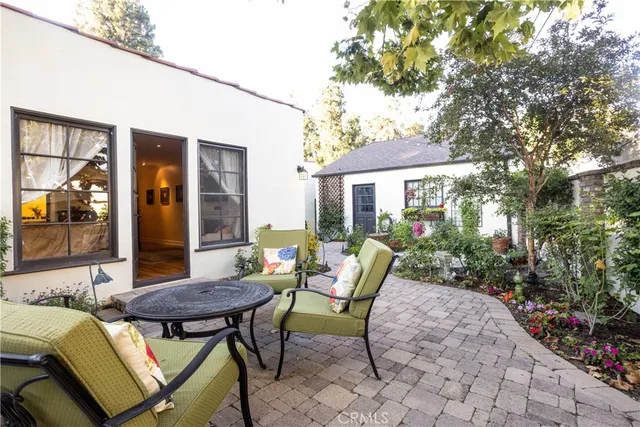 a view of a porch with lots of potted plants and a fountain