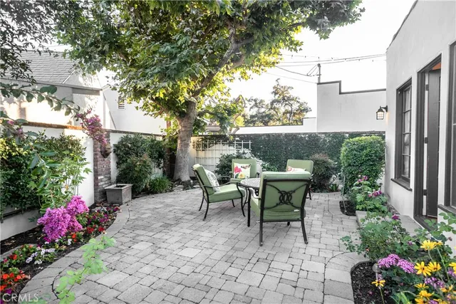 a view of a patio with table and chairs and potted plants