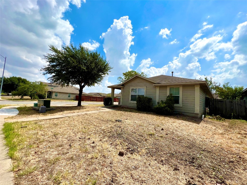 14200 Briarcreek Loop Manor, TX 78653 - Photo 18 of 20 a front view of a house with a yard