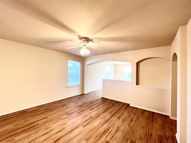wooden floor in an empty room with a window