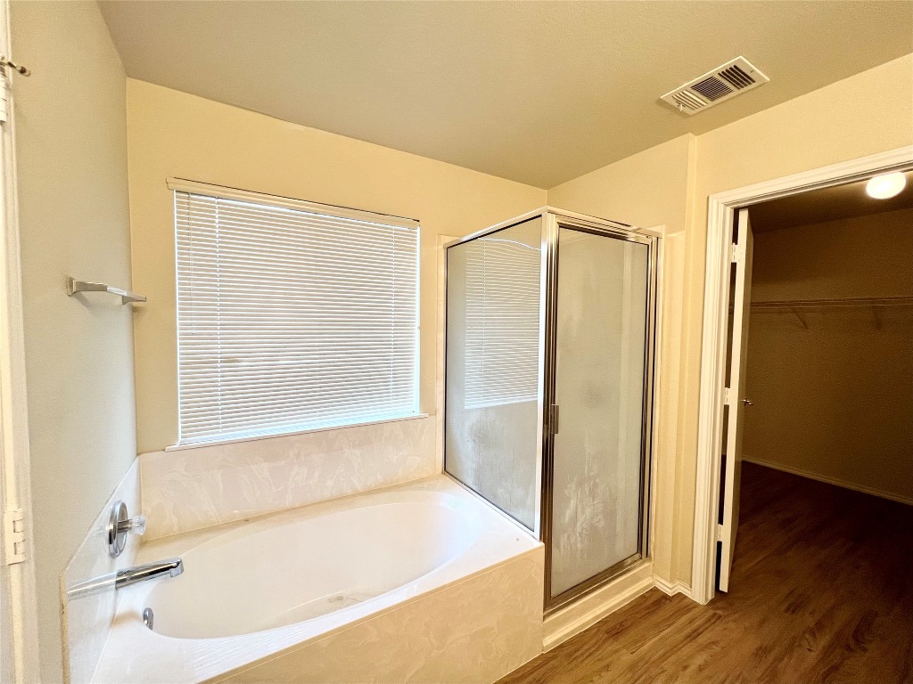 14200 Briarcreek Loop Manor, TX 78653 - Photo 8 of 20 a bathroom with a bathtub and a shower