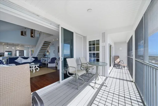 a view of a hallway with wooden floor and cabinet