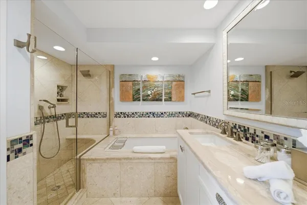 a bathroom with a granite countertop sink a toilet and shower