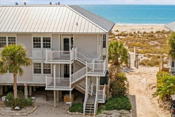 a view of a house with a barbeque and wooden floor