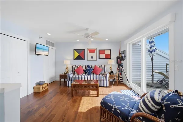 a view of roof deck with two chairs and wooden fence