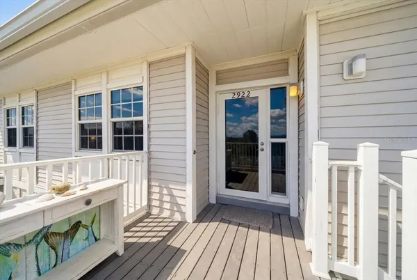 a dining room with wooden floor and large windows
