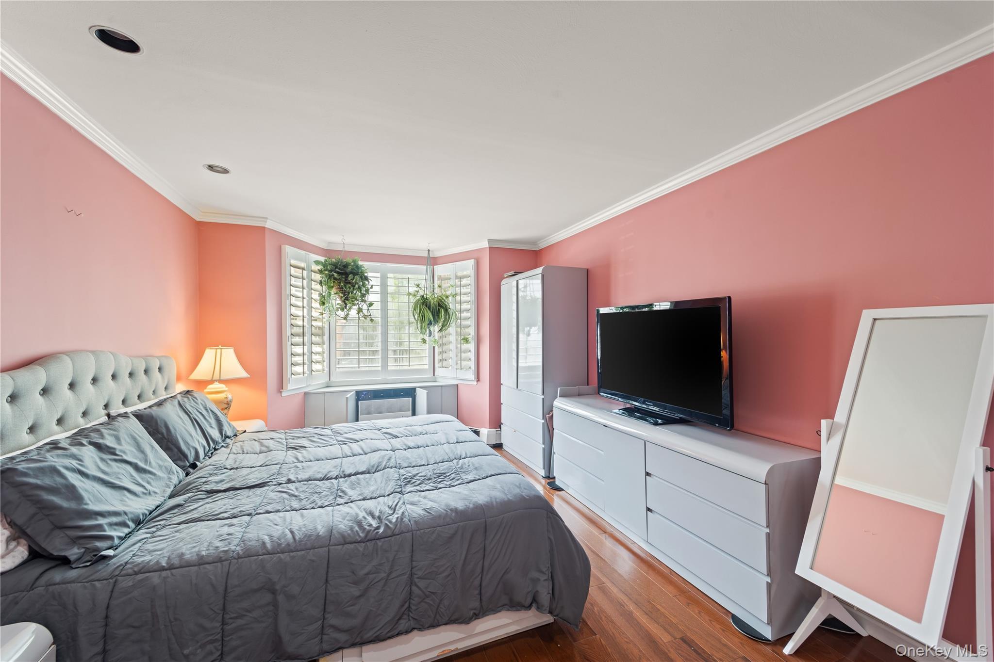 12-35 Robin Lane, Unit UPPR Queens, NY 11360 - Photo 12 of 23 Bedroom with crown molding and wood finished floors