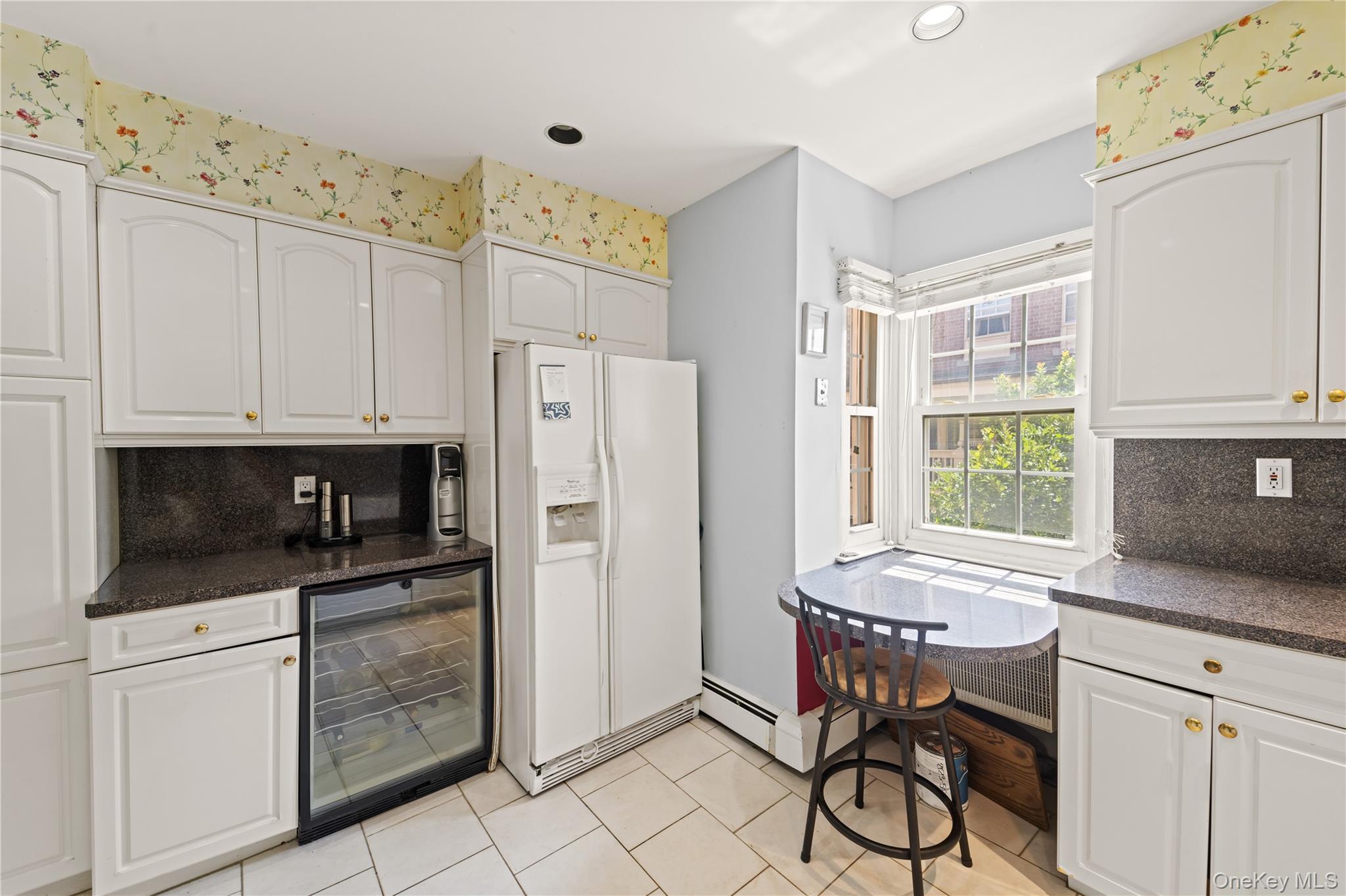 12-35 Robin Lane, Unit UPPR Queens, NY 11360 - Photo 14 of 23 Kitchen with decorative backsplash, beverage cooler, white refrigerator with ice dispenser, white cabinetry, and dark stone counters